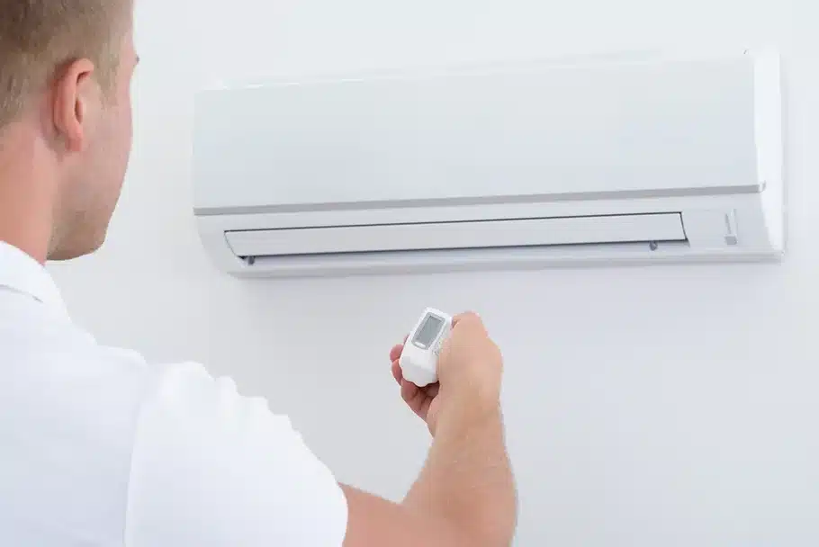 man trying to figure out how to use an air conditioning unit